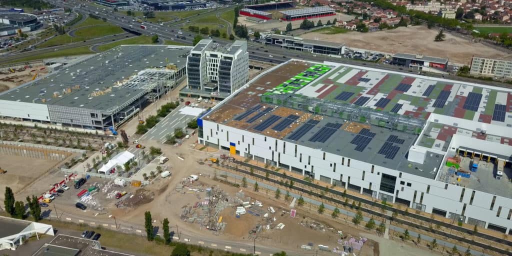 Vue aérienne d'un centre commercial en chantier et de sa toiture photovoltaïque