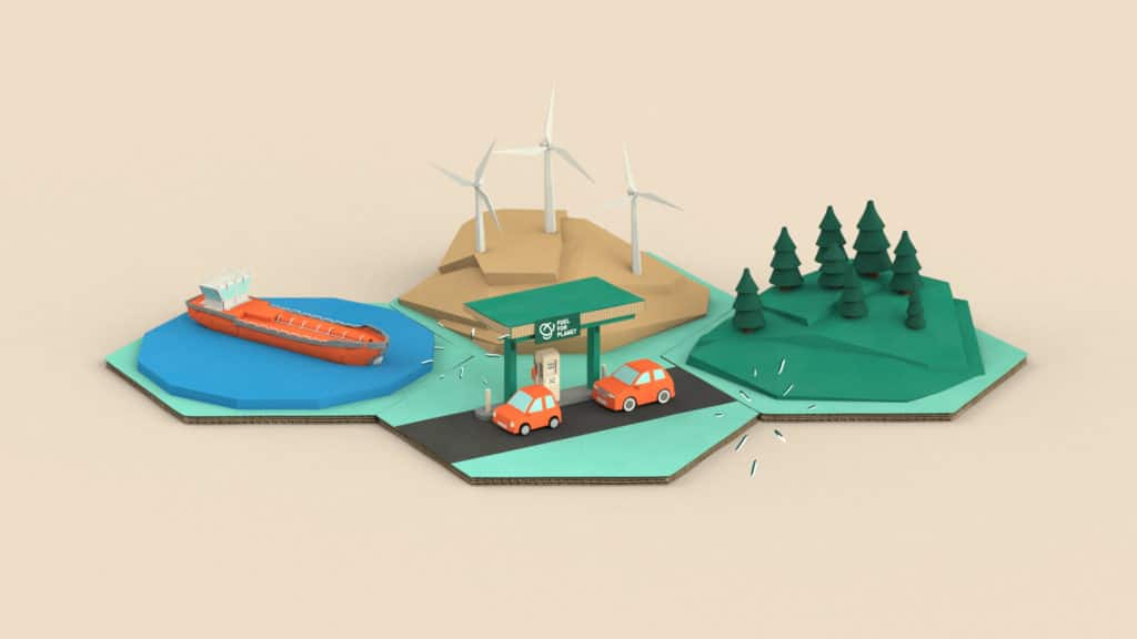 Station-service Fuel For Planet entourée d’éoliennes, d’une forêt et d’un cargo, décor 3D en carton