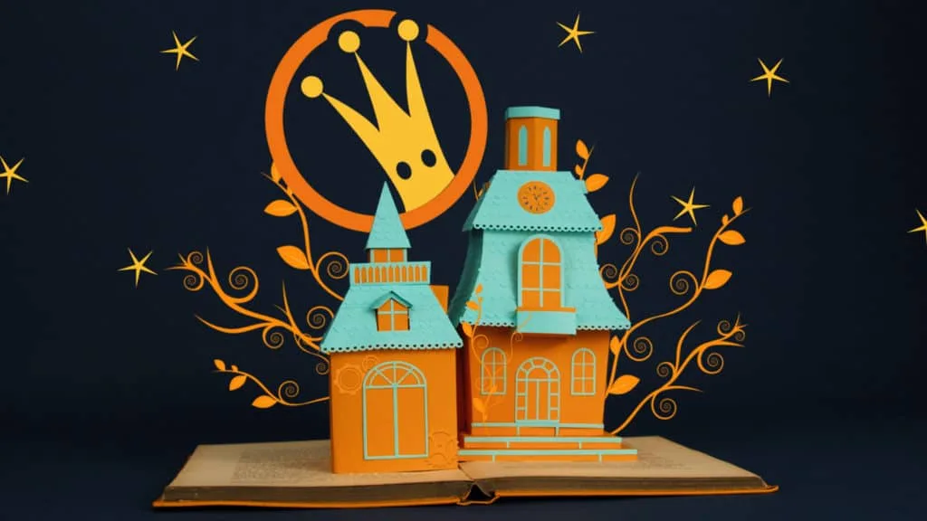 Maison en paper art posée sur un livre ouvert, décor construit à la main pour le film Lunii FLAM